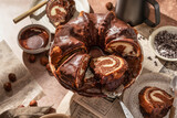 Chocolate marble bundt cake or zebra cake with chocolate glaze sliced on brown table background