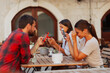 © Novak - Group of friends distracted by mobile phones while sitting together in a coffee shop