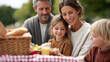 © Sergey - Happy family enjoying outdoor picnic in park with food on blanket