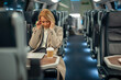© Jelena - Stressed business woman suffering headache during train travel