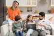 © New Africa - Happy family with laptop spending time together on sofa in kitchen at home
