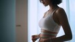 © Line - Woman measure waist with tape by window light for fitness and diet