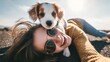 © CreativeArt - Happy young woman smiling, holding cute puppy on head, enjoying outdoor leisure moment and pet companionship. Dog on a walk