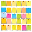 © mantu - Assortment of colorful sticky notes, pinned to a white backdrop