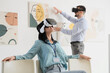 © Pixel-Shot - Young woman with VR glasses sitting in art gallery