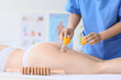 © Pixel-Shot - Young woman getting anti-cellulite massage with vacuum jars in clinic