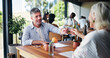 © peopleimages.com - Conversation, couple and toast with man in restaurant together for bonding or relationship. Cheers, romance and love with mature person drinking wine at table for break, connection or hospitality