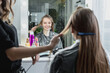 © Maria - Hairdresser brushing long blonde hair with brush in beauty salon