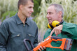 © auremar - landscape gardener training his apprentice to use machine