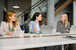 © Westend61 - Business woman working and discussing in a modern office environment