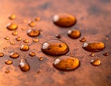 Droplets of liquid resting on a textured bronze surface