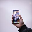 ©  zs stock  - A person holding a smart mobile phone with a blank touch screen display represents modern wireless communication technology and business gadget connectivity