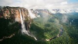 Angel falls plunges from auñán-tepui into a misty tropical valley in canaima national park, venezuela, with lush jungle below and a vibrant rainbow arching over the falls