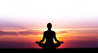 © Martin - Silhouette meditant sereinement au coucher du soleil ardent couleurs orange et violet evoque paix interieure. AI Generated