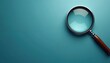 © miss irine - Magnifying glass rests on teal background suggesting research, discovery. Tool aids in detailed examination, finding information. Explore ideas, analyze data, uncover insights with simple object.