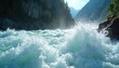 © miss irine - Turbulent river flows fast through rocky mountainside canyon. White water rapids crash and splash with foamy spray. Sun shines brightly on the water creating beautiful natural scene.