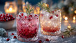 © Екатерина Чумаченко - Festive pomegranate cocktails with ice and rosemary sprigs. Sparkling drinks on a cool surface, perfect for holiday celebrations.