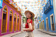 © zigres - Tourism in Olinda, Brazil. Portrait of tourist woman visiting Olinda the city of famous Brazilian Carnival.