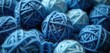 © Vadym - Pile of blue yarn balls in various shades for crafting. Cozy textile background with soft wool fiber for knitting, crocheting, and sewing projects.