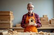 © Pete - Smiling senior man with glasses in apron holds small wooden birdhouse. Craftsman in workshop with stacks of lumber and wood shavings. Happy carpenter shows finished product.