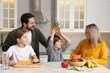 © New Africa - Happy family cooking and having fun together at table in kitchen