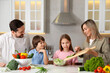 © New Africa - Happy family cooking together at table in kitchen