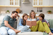 © New Africa - Happy family reading book and spending time together on sofa in kitchen at home