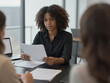 © Đào Tuấn Anh - Serious African American Businesswoman Reading Documents During Office Meeting
