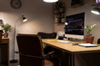 © Pixel-Shot - Programmer's desk with computer and glowing lamps in office at night