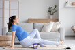 © Pixel-Shot - Sporty pregnant woman training with foam roller on fitness mat at home