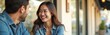 © Maryna - Young asian woman laughs while talking with man outdoors. Couple enjoys conversation at cafe terrace. Friends share happy moment. They look at each other, smiling warmly. Relaxed lifestyle scene.