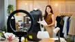 © Stella 16 - Asia female blogger review product and talking camera live recording video on social network at home, Online selling clothes on social media