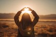 © Alona - Woman framing the sun with her hands at dawn to symbolize future planning and forward thinking