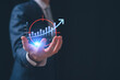 © cherdchai - Businessman Hand holding growth business strategy arrow up concept on success target improvement with increase development graph profit or economy investment income target goal increase achievement.