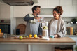 © Jelena - Couple In Modern Kitchen Making Smoothie Together With Blender And Fresh Fruit