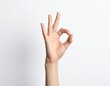 © Ulrich - Hand shows OK sign with fingers in a clear position against a light background