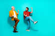 © deagreez - Two friends and a senior man dancing together in bright teal studio showing joy energy and friendship