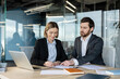 © Liubomir - Businesswoman signing a document, negotiating a partnership agreement or making a deal with a male colleague during a corporate meeting in a modern office