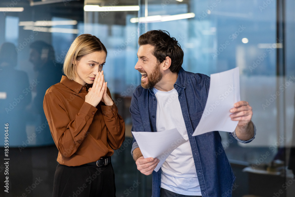 Angry male boss yelling at a stressed female employee holding her hands ...