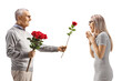 © Ljupco Smokovski - Elderly man giving a red rose to a young woman