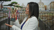 © Krakenimages.com - Chinese woman happily holding trophy outdoors with roman ruins in background.