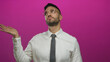 © Krakenimages.com - Young hispanic man wearing glasses and white shirt gestures dismissively against vibrant pink background
