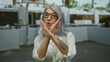 © Krakenimages.com - Senior woman with glasses and grey hair making hand gestures on a sunny street, showcasing expression and attitude in an outdoor setting, wearing a white shirt.