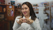 © Krakenimages.com - Woman puckers lips for kiss gesture with both hands raised and direct eye contact in studio; friendly affection.