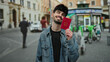 © Krakenimages.com - Happy man holding italian passport on a bustling urban street, showcasing travel readiness and joy in an outdoor city setting, with a bright smile and casual attire.