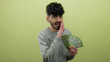© Krakenimages.com - Man holding russian ruble banknotes over yellow background looking confident and whispering.