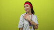 © Krakenimages.com - Woman smiling confidently wearing gold medal against bright yellow background showing youthful energy and achievement