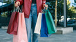 © shine.graphics - Woman holding multiple shopping bags in front of a modern building, showcasing consumerism and retail therapy.