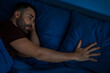 © Home-stock - Unhappy lonely man touching pillow lying in bed suffering from loss or breakup at night. Loneliness problem, divorce. Low light shot