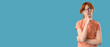 © Pixel-Shot - Portrait of thoughtful teenage redhead girl on blue background